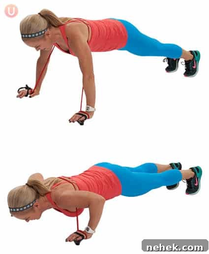 Chris Freytag demonstrating a resistance band push up wearing a red top and blue workout pants