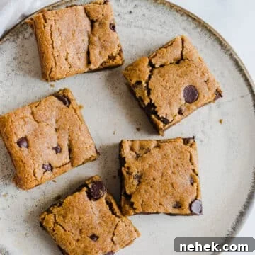Gluten-Free Pumpkin Chocolate Chip Blondies — Fall Dessert Recipe 13 Blondies with chocolate chips on a plate.