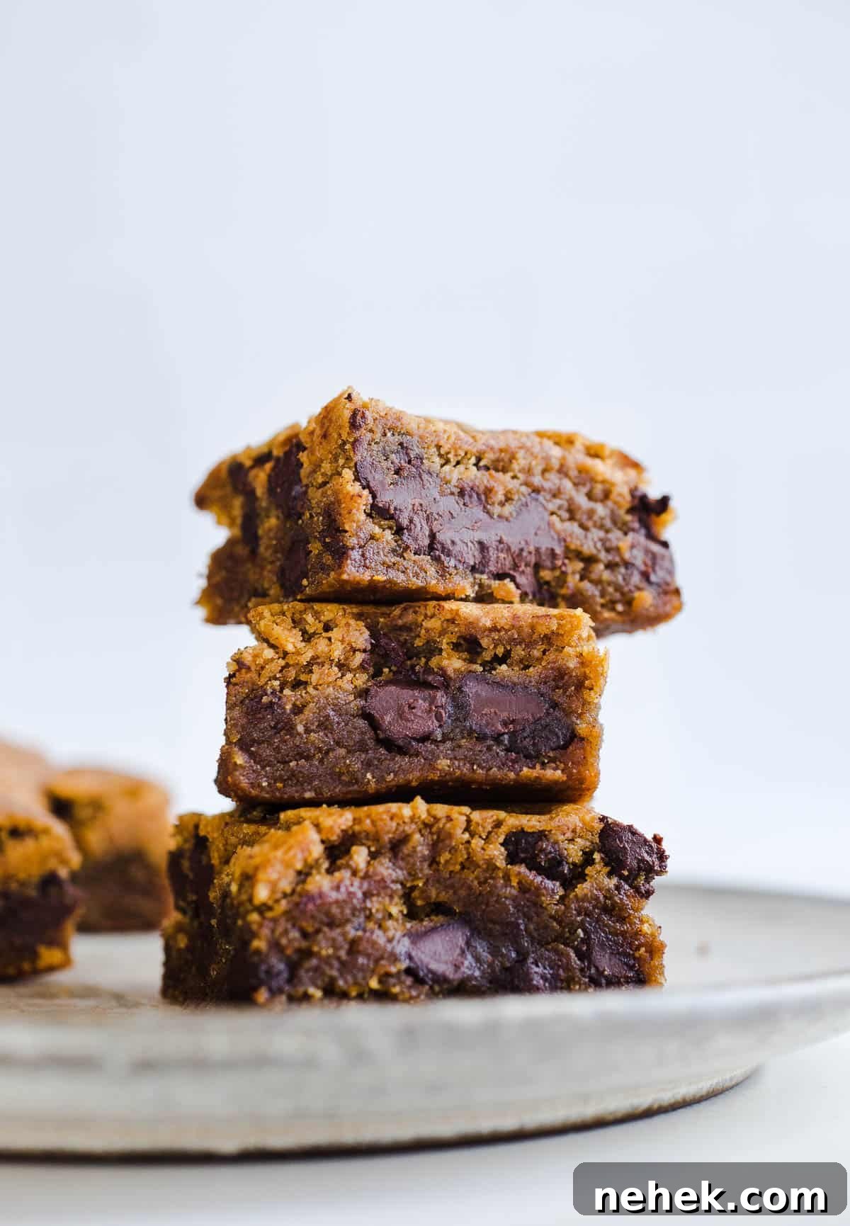 Gluten-Free Pumpkin Chocolate Chip Blondies — Fall Dessert Recipe 8 Chocolate chip blondies stacked on a plate.