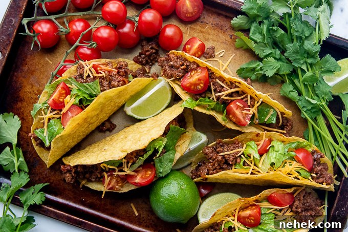 Sweet and Spicy Sloppy Joe Tacos with Lime Sour Cream 9 overhead shot of spicy ground beef tacos with fixings on a baking sheet
