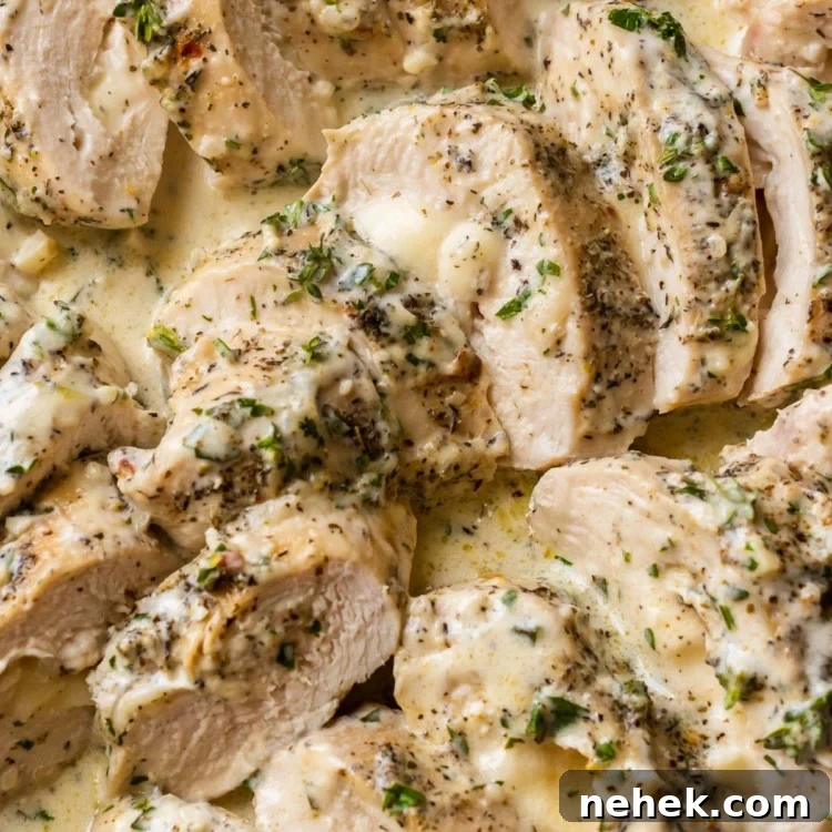 slices of chicken breast in a mozzarella cream sauce topped with herbs