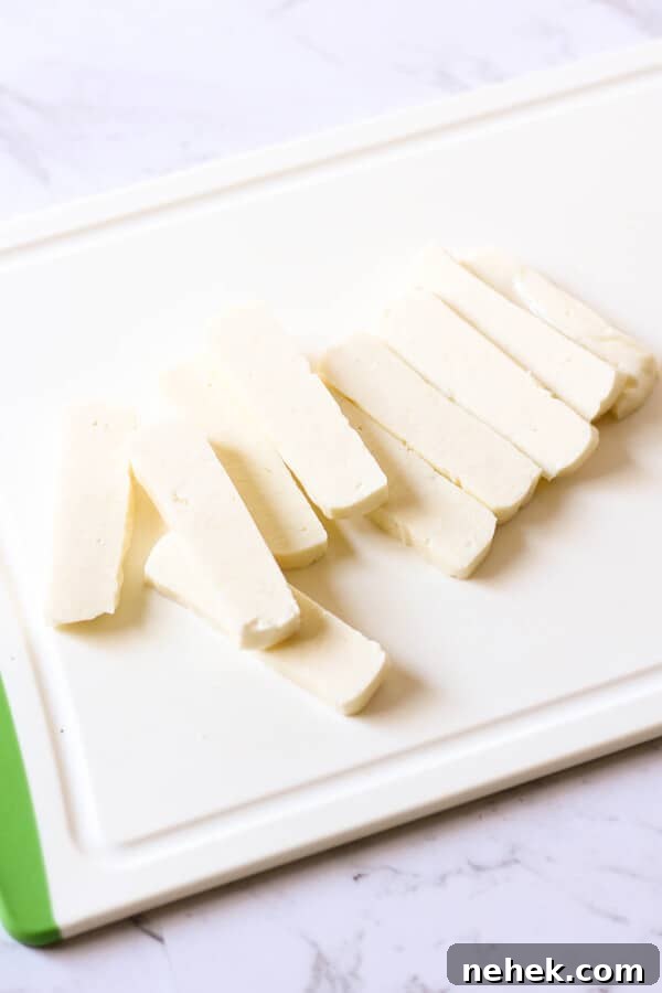 chopped halloumi slices on a cutting board.