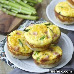 Mini Quiche cups are packed with tender ham, fresh asparagus and sharp cheddar cheese for a easy Spring brunch!
