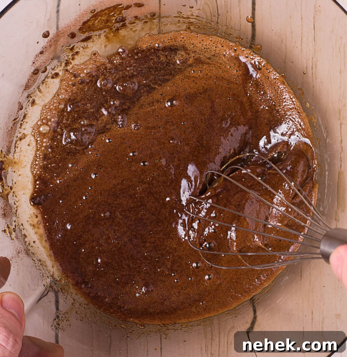whisking instant coffee, water, and sugar in a bowl
