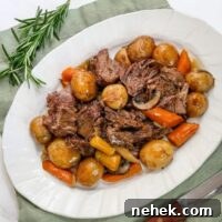 an onion soup pot roast from the slow cooker, shown on a serving platter with vegetables