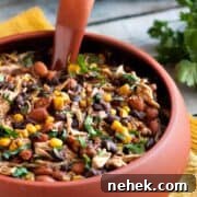 Large red bowl of delicious Slow Cooker Salsa Chicken Chili with corn and beans.
