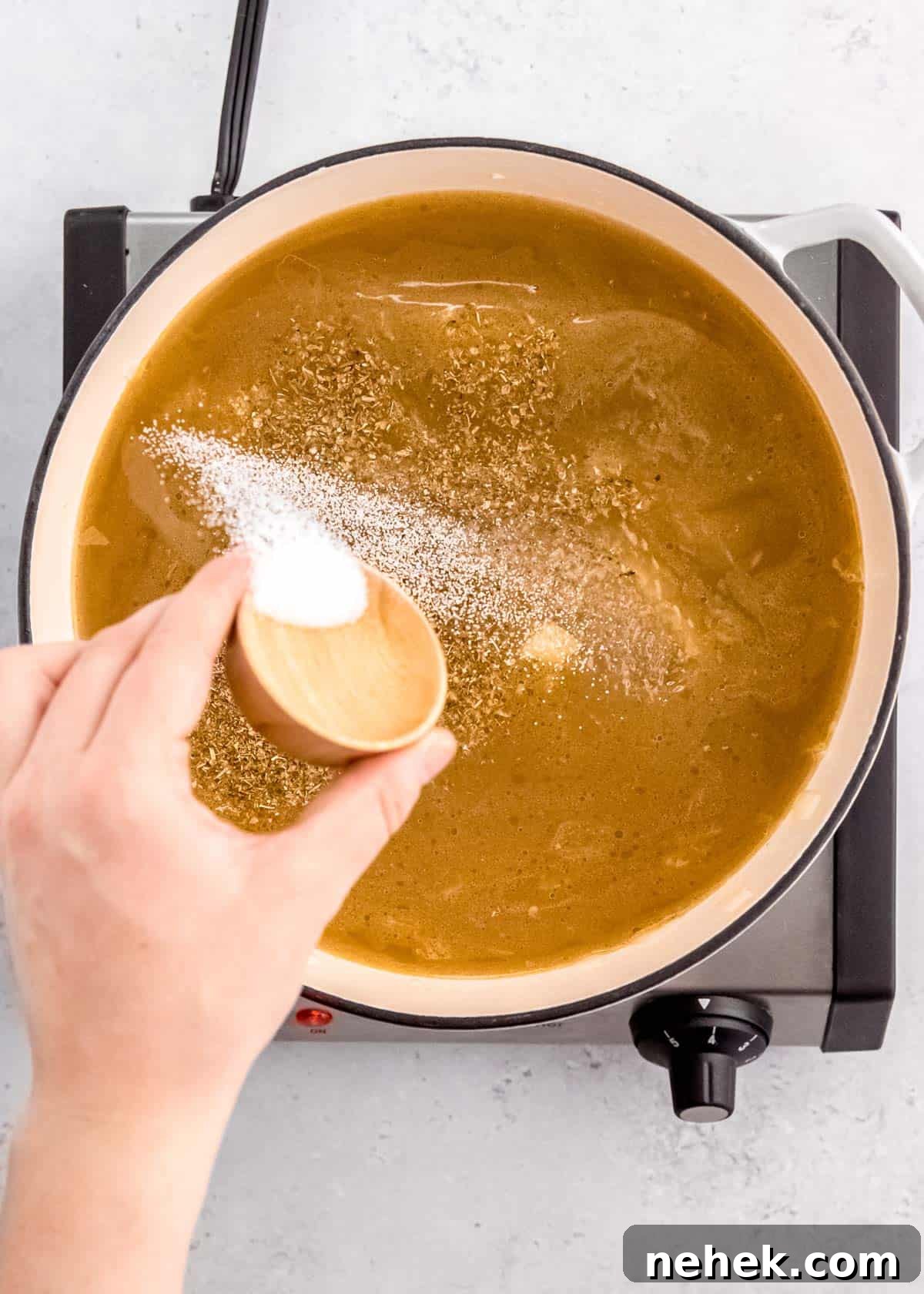 Classic Homemade Chicken Noodle Soup Recipe for Comforting Meals 6 seasonings sprinkled into a dutch oven filled with broth and vegetables