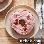 Strawberry cream cheese on a bagel.