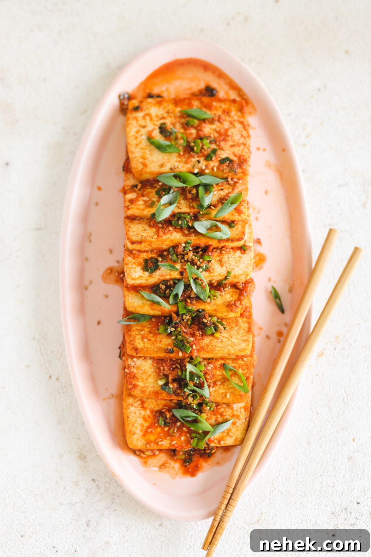 50 Vegan Tofu & Tempeh Recipes for Delicious Plant-Based Meals 2 a pink platter filled with dubu jorim next to chopsticks