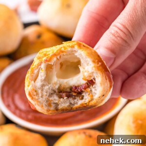 bacon bomb cut in half showing the bacon and cheese inside