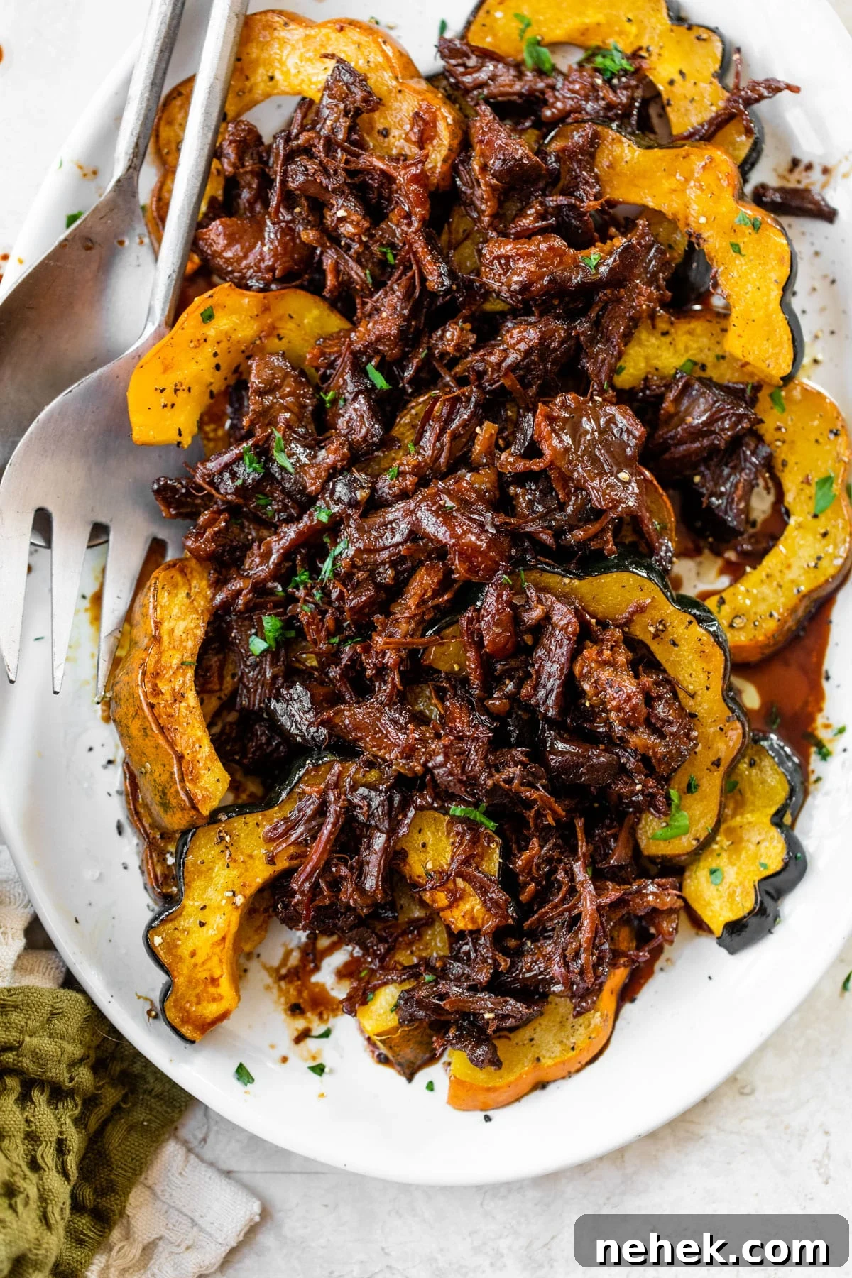 roasted acorn squash on a platter topped with pulled pork