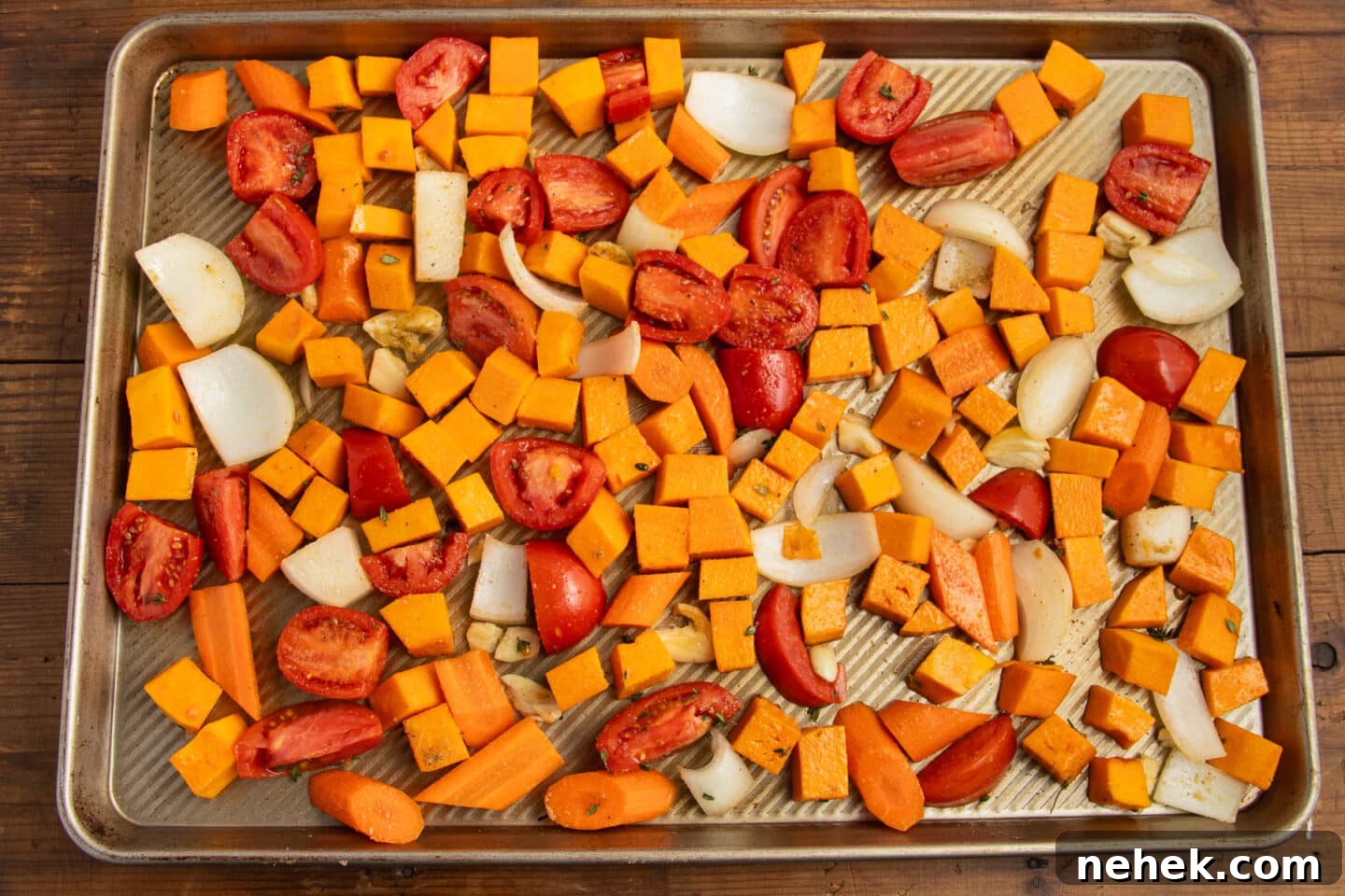 Roasted Tomato and Butternut Squash Soup Recipe 5 This is a picture of a large baking sheet with tomato, butternut squash, onions and carrots.