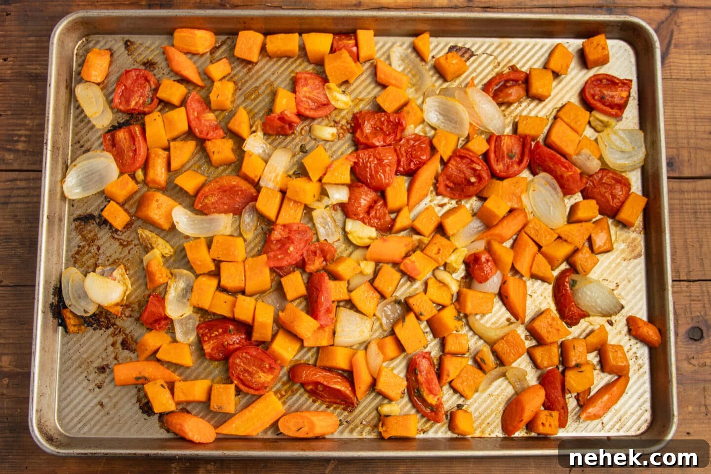 Roasted Tomato and Butternut Squash Soup Recipe 7 This is a picture of a large baking sheet with tomato, butternut squash, onions and carrots after baking them.