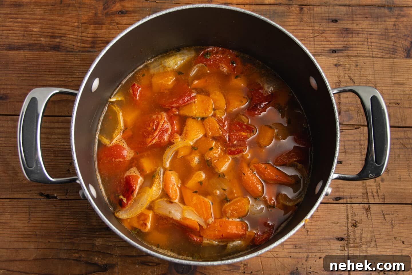 Roasted Tomato and Butternut Squash Soup Recipe 8 This is a picture of the cooked veggies added to the pot with broth.