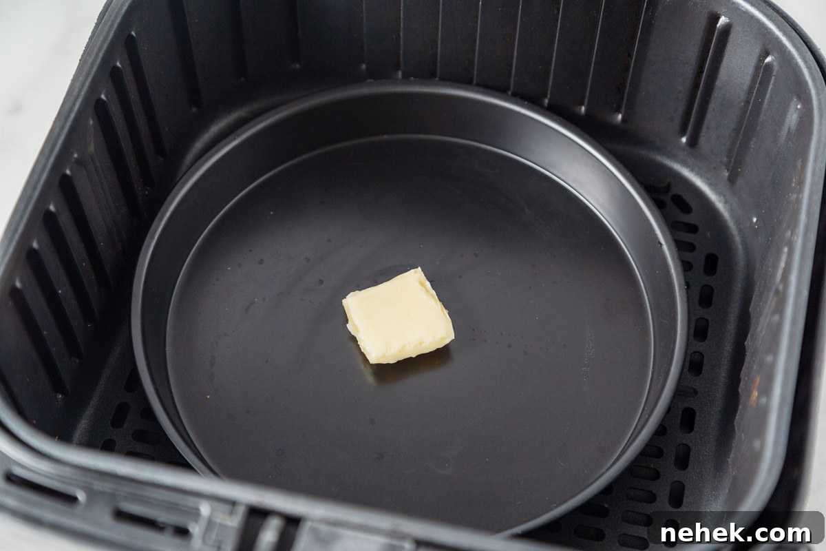 placing butter on a pan inside the air fryer.