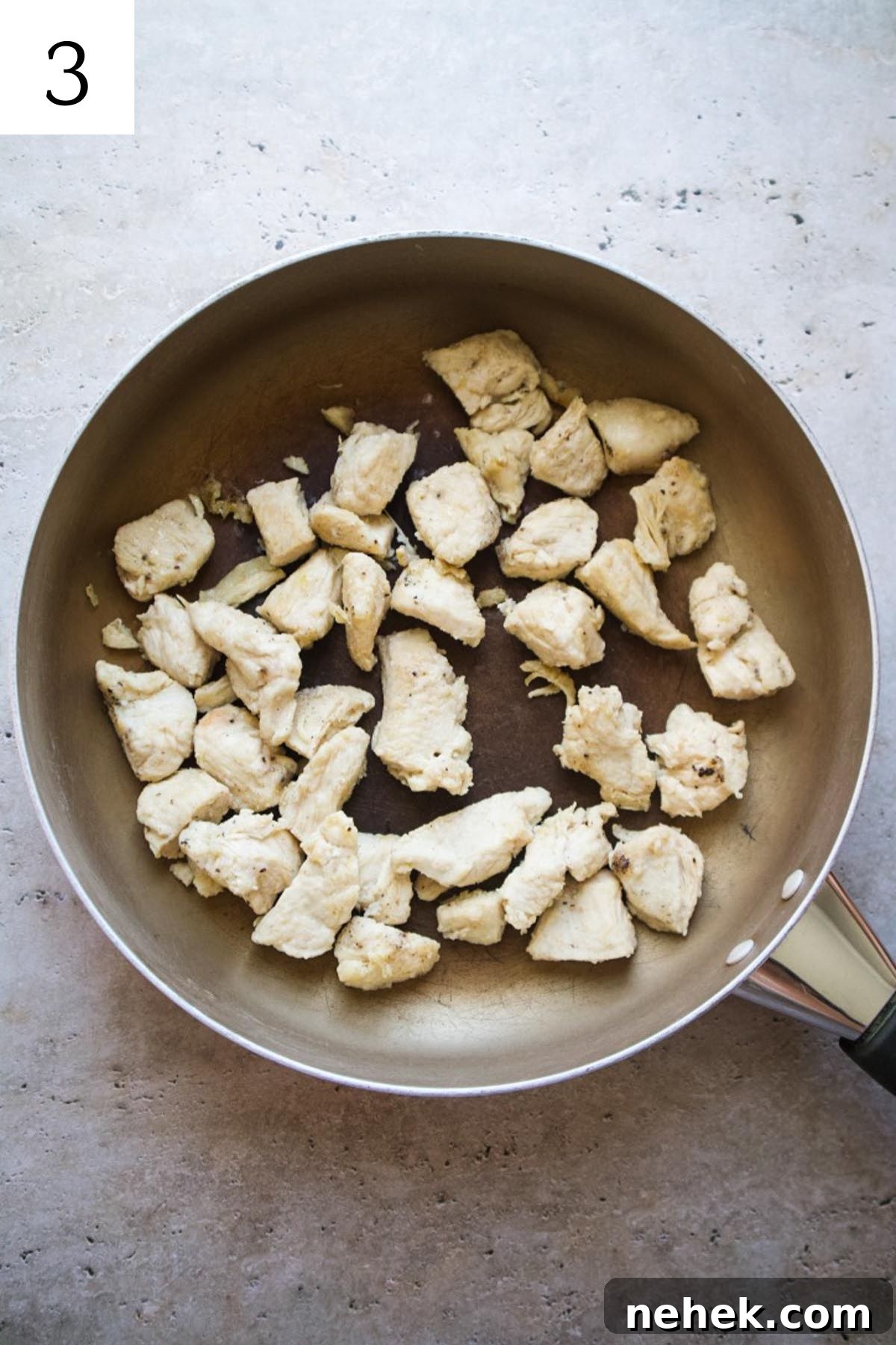 skillet with cooked chicken.
