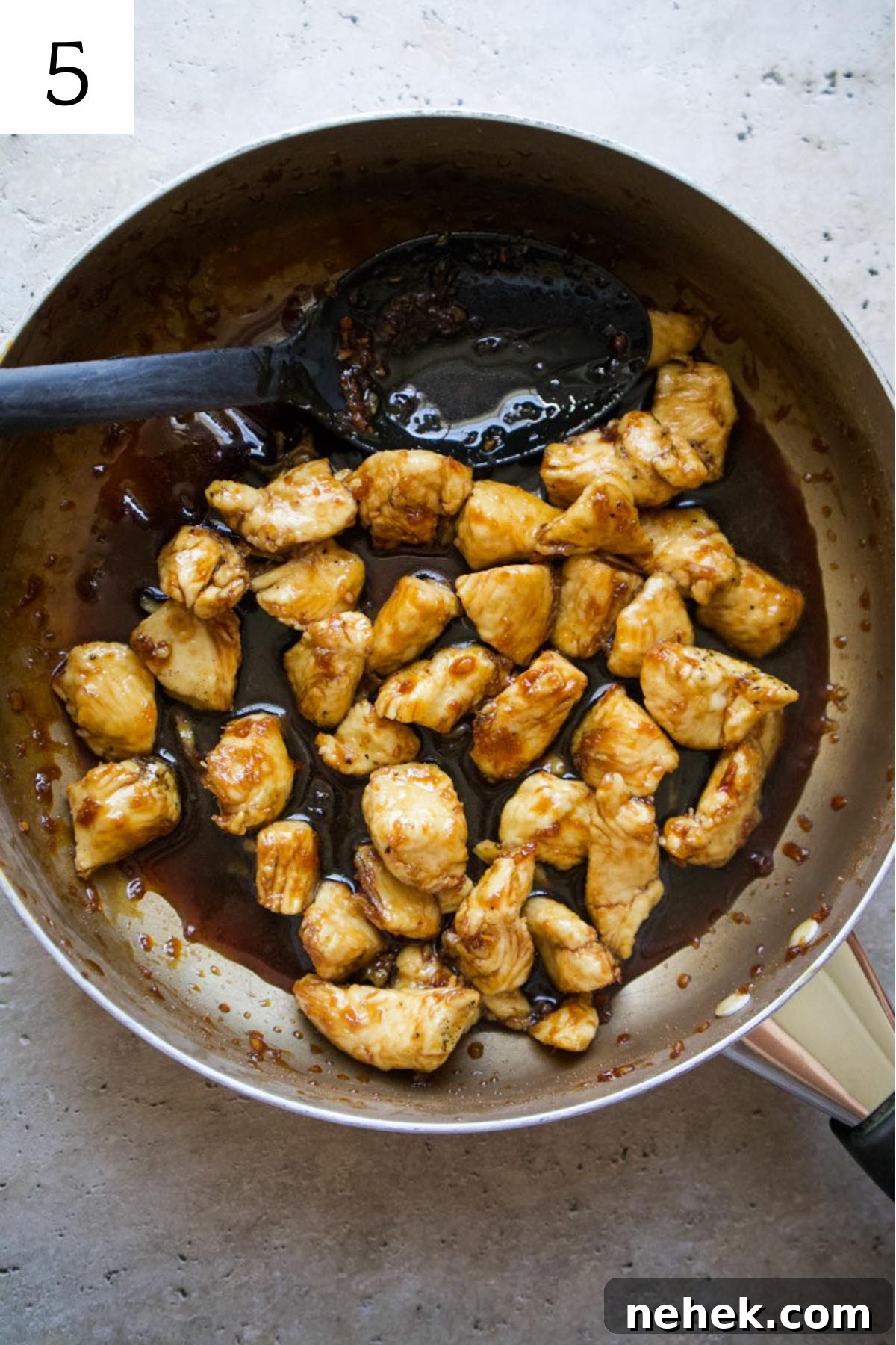 skillet with chicken in a honey ginger sauce.