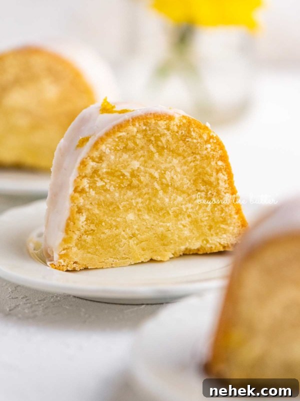 Quick Single-Layer Chocolate Cake Recipe for Perfect Moistness 12 Small lemon cream cheese pound cake slice on a small dessert plate on white background.