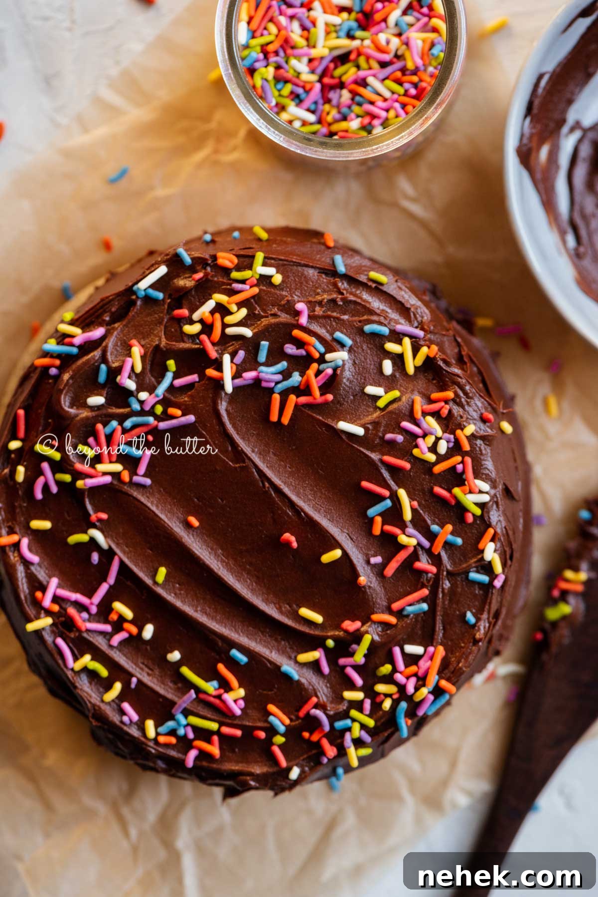 Quick Single-Layer Chocolate Cake Recipe for Perfect Moistness 6 Overhead image of single layer chocolate cake with bowl of milk chocolate frosting | All Images © Beyond the Butter®