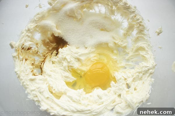 Cream cheese mixture ingredients in a clear bowl.