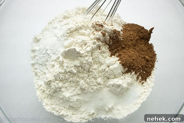 Dry ingredients in a clear bowl with whisk.