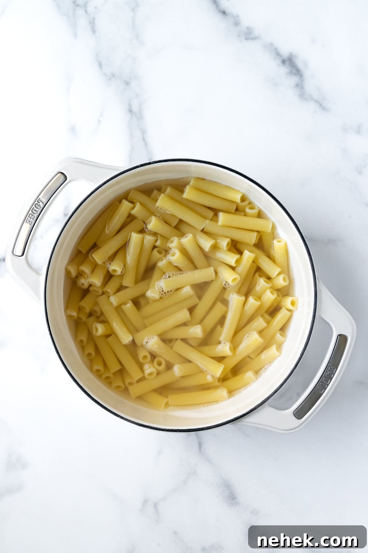 Cheesy Vegetable Baked Ziti with Roasted Tomatoes and Spinach 4 Ziti Cooking in a White Pot of Water.