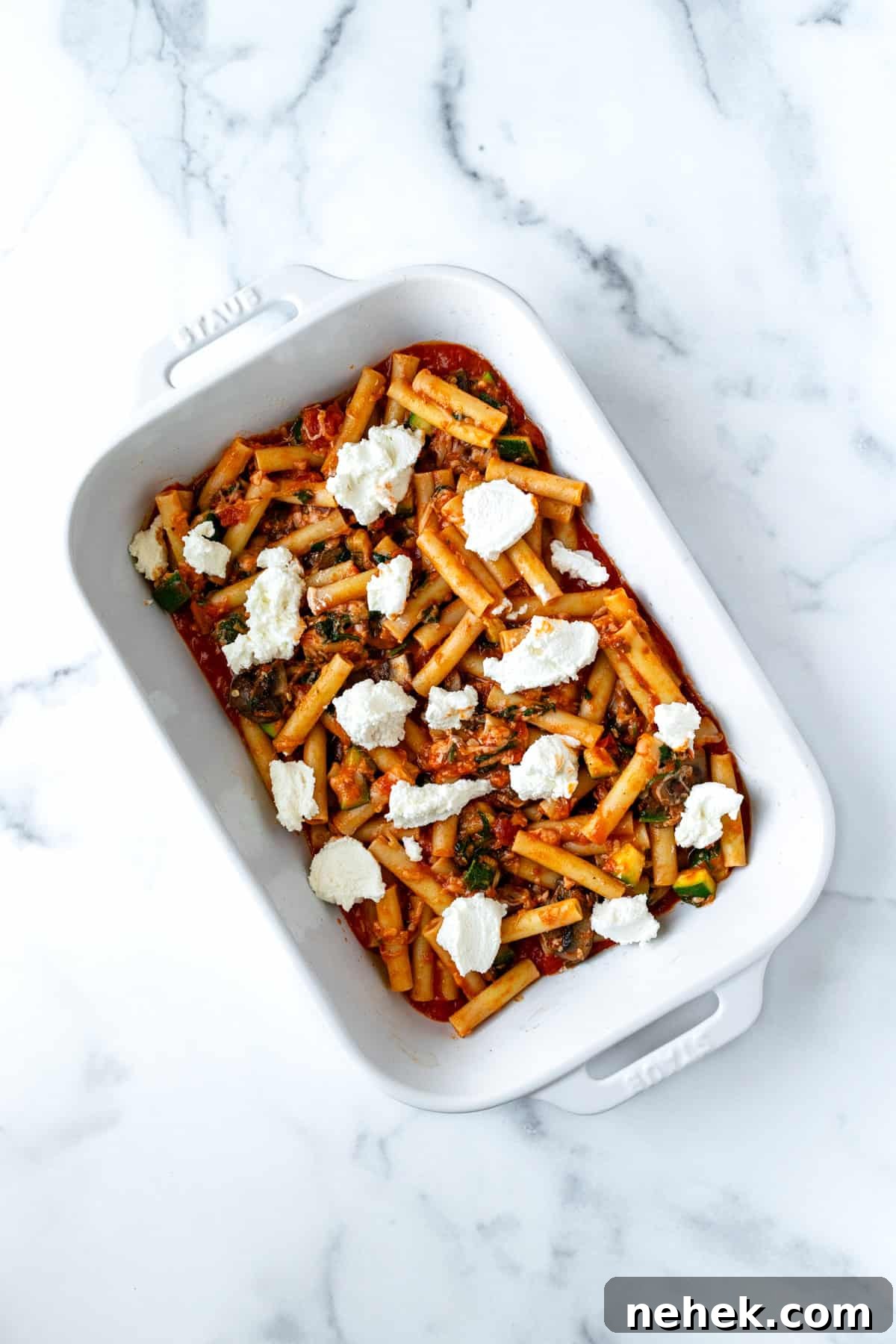 Cheesy Vegetable Baked Ziti with Roasted Tomatoes and Spinach 7 Vegetable Baked Ziti Before baking in a white casserole dish.