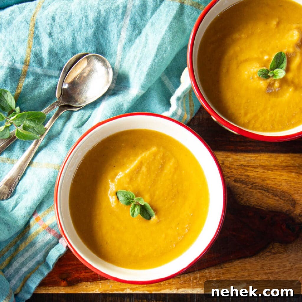 Creamy Spiced Pumpkin Soup Made with Canned Pumpkin 3 Two bowls of roasted eggplant soup pureed with a tomato, along with two spoons.
