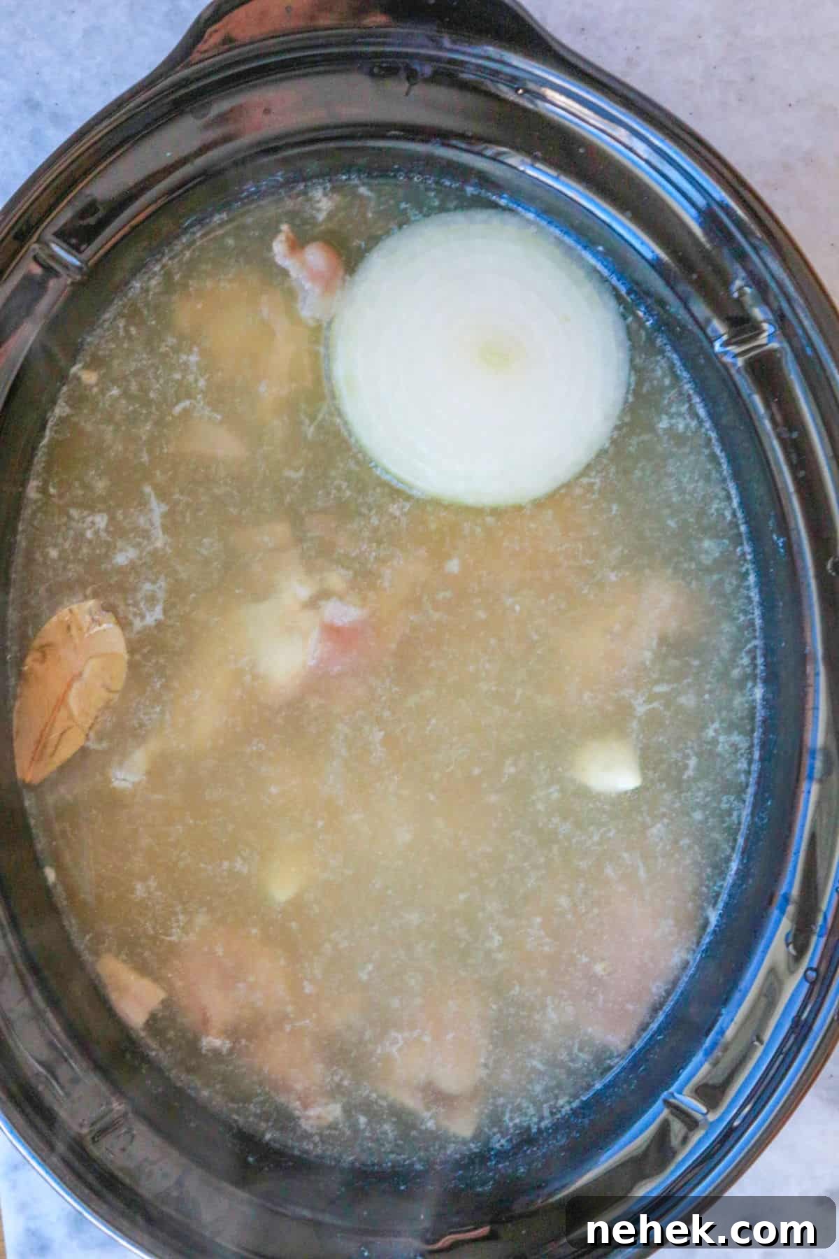 White pozole cooking in slow cooker
