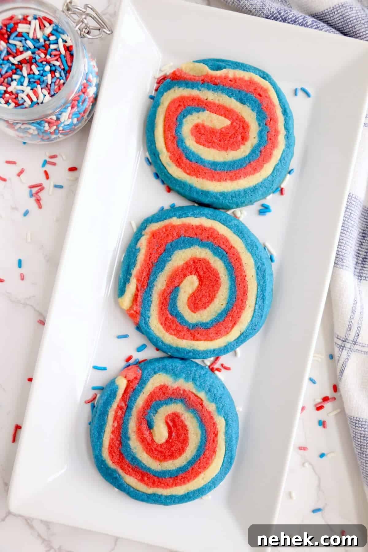 Patriotic Red, White & Blue Sugar Cookie Recipe 2 red, white and blue cookies in a pinwheel shape