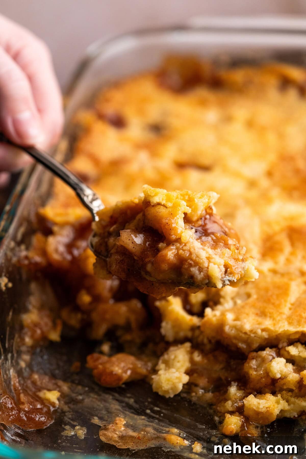 Scoop of Caramel Apple Dump Cake being lifted out of the pan