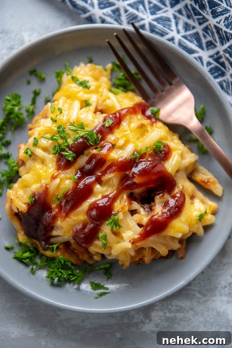 sloppy joe casserole on a gray plate with a fork