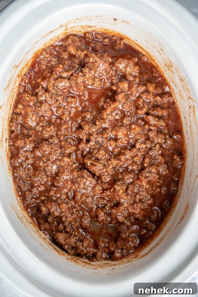 sloppy joe mixture in a white slow cooker