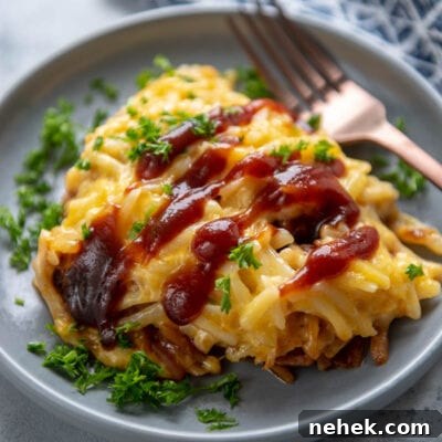 sloppy joe casserole on a gray plate with fork