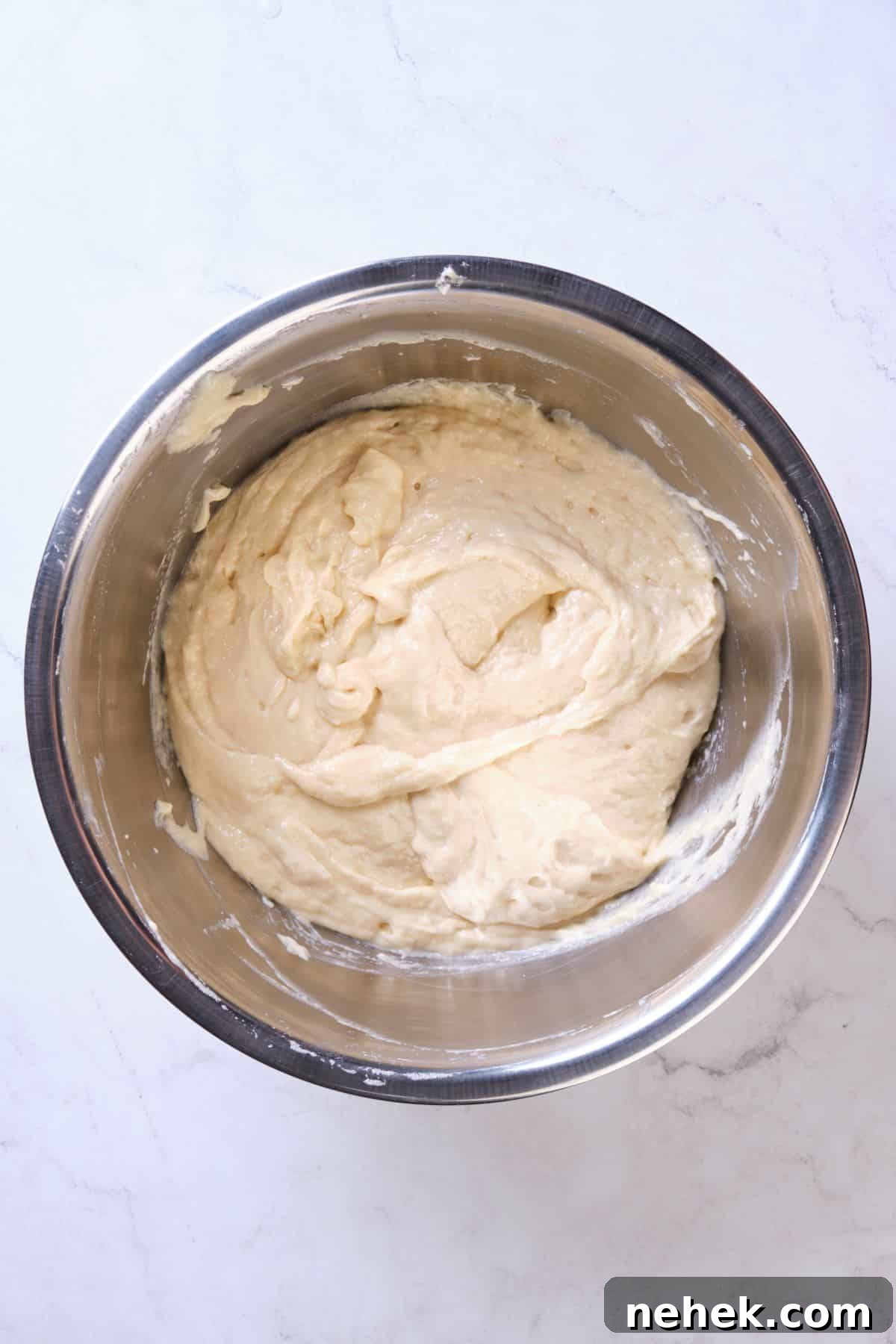cake batter after folding in egg whites using the traditional creaming method.