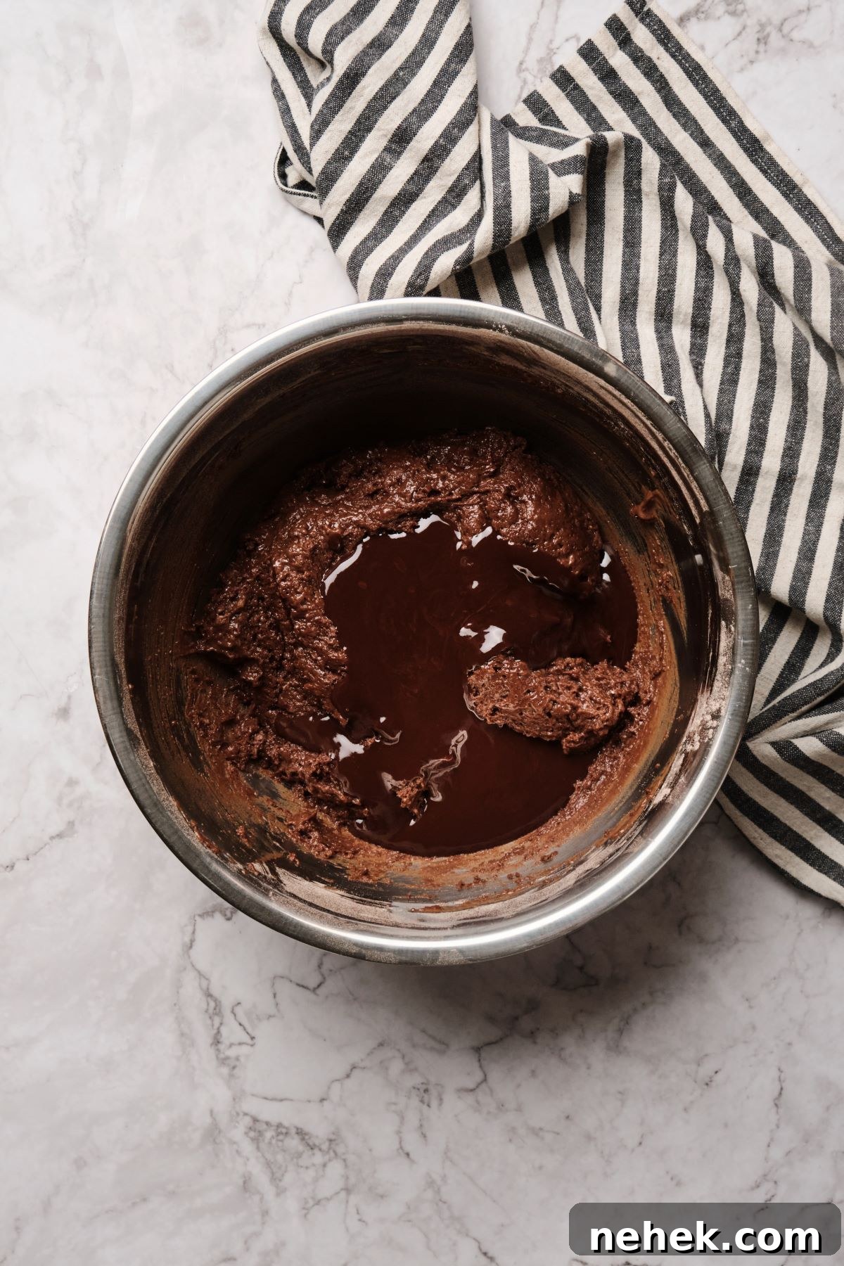 mixing the wet and dry ingredients together in a bowl, then adding melted butter.