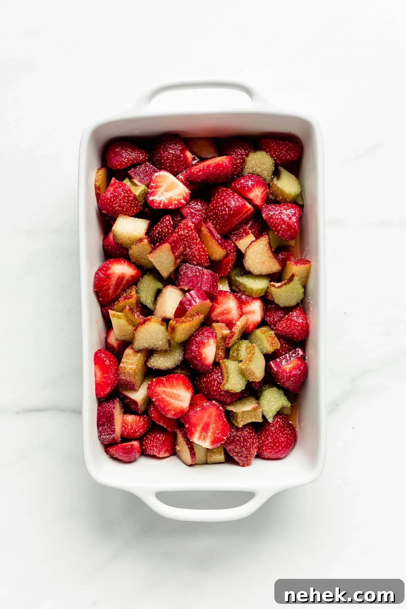 strawberries and rhubarb in a baking dish.