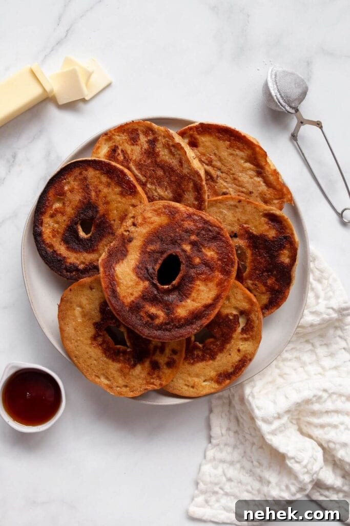 Cinnamon French Toast Bagels with Maple Glaze 7 crispy french toast bagels on a serving plate