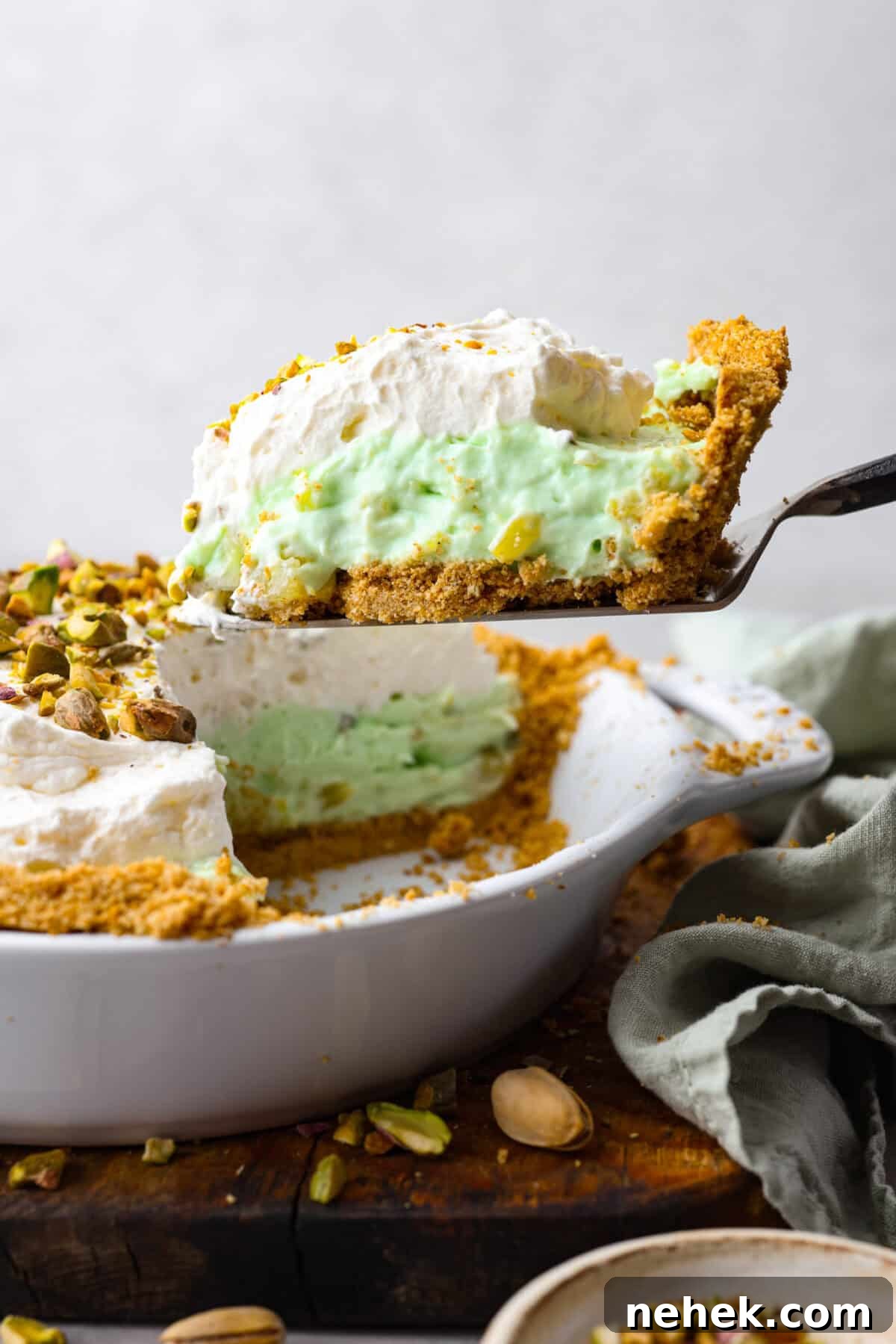Close side view of a slice of pie lifting from the pie dish.