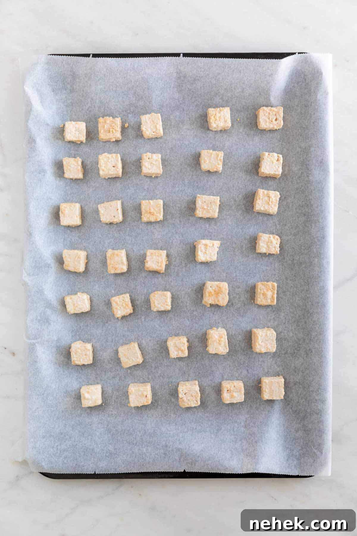 Crispy Oven-Baked Tofu with Golden Crunch 6 Tofu cubes onto a lined baking sheet before baking.
