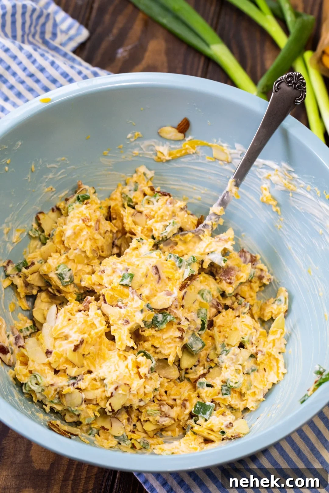 Copycat Neiman Marcus Dip Recipe for Parties 3 Dip being stirred together in a large blue mixing bowl.