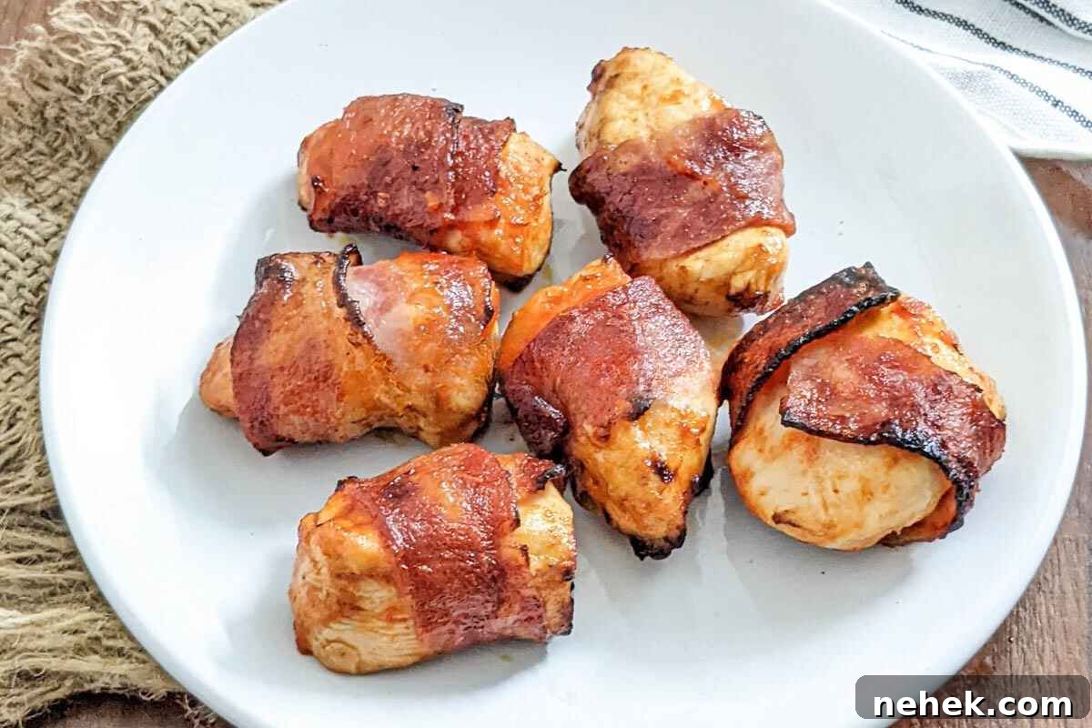 Air Fryer Recipes That’ll Stay on Your Menu Forever 6 Bacon wrapped chicken served on a plate