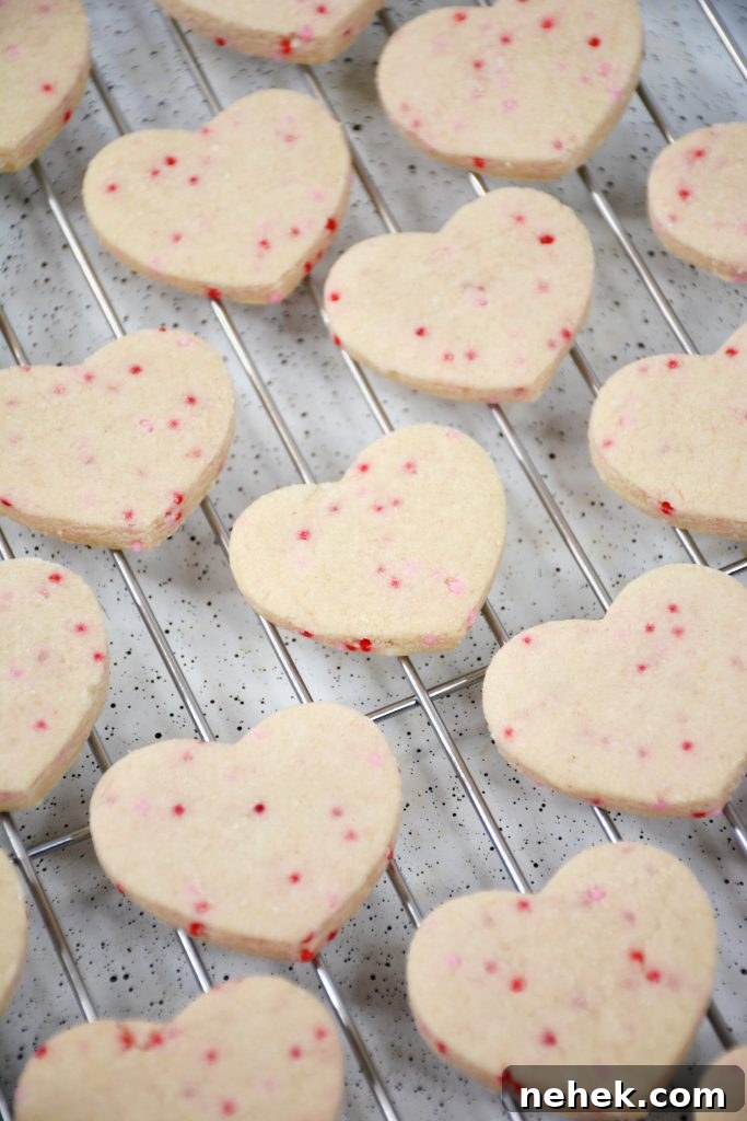 Mini Valentine Shortbread Cookies Recipe for Cute Heart Treats 4 mini heart shaped cookies cooling on a wire rack.