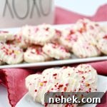 Mini Valentine Shortbread Cookies Recipe for Cute Heart Treats 9 Plateful of heart-shaped mini Valentine shortbread cookies in front of serving platter with more Valentine cookies