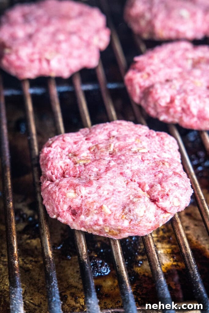 How to Make Smoked Burgers That Stay Juicy and Flavorful 4 uncooked hamburgers on the smoker