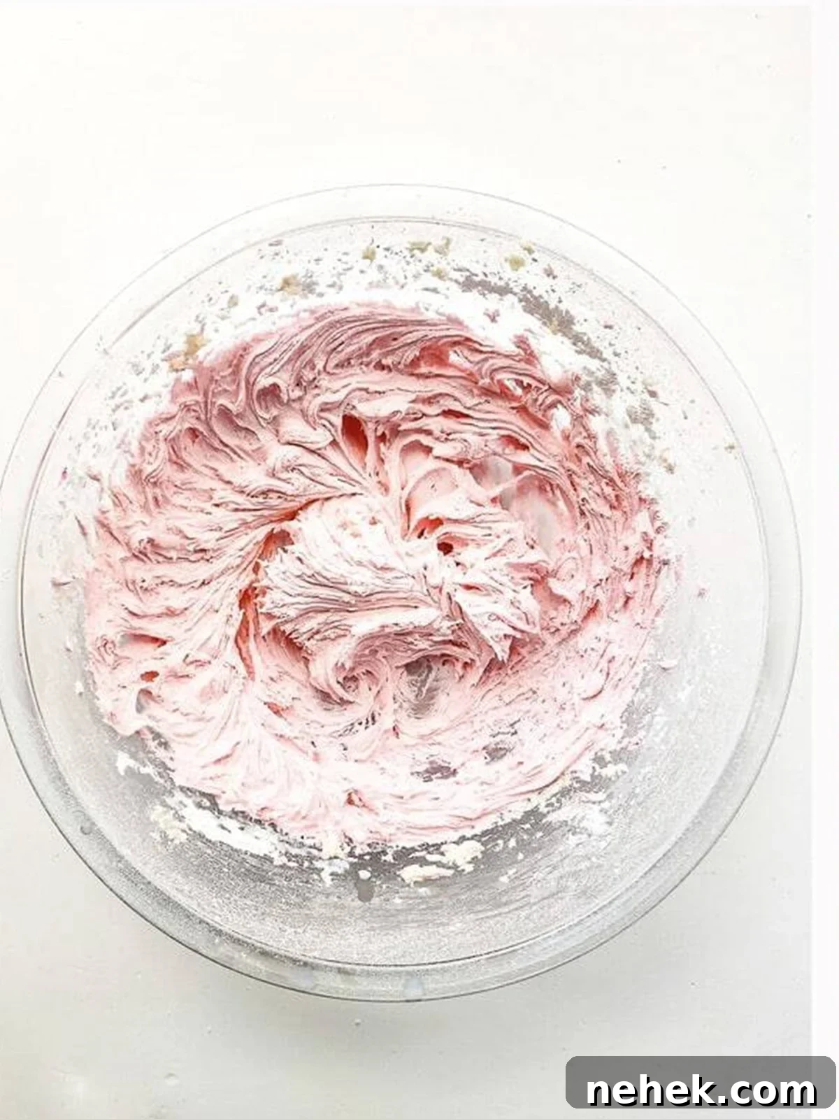 Chocolate Whoopie Pies with Strawberry Frosting Recipe 8 Whipping fluffy pink strawberry frosting in a bowl for whoopie pies.