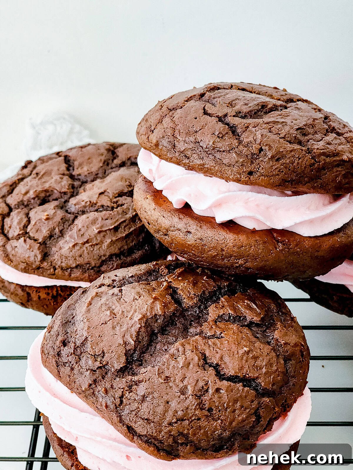 Chocolate Whoopie Pies with Strawberry Frosting Recipe 10 Stacked chocolate whoopie pies with fluffy strawberry frosting filling.