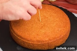 Perfect Lemon Drizzle Cake Recipe — Moist, Zesty Slice 12 Poking holes into the lemon cake with a cocktail stick