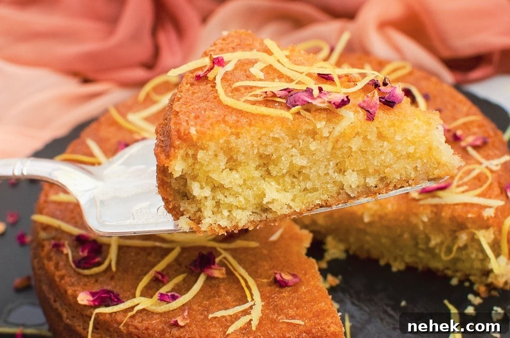 Perfect Lemon Drizzle Cake Recipe — Moist, Zesty Slice 26 Slice of flawless lemon drizzle cake on a silver cake knife