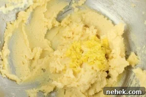 Perfect Lemon Drizzle Cake Recipe — Moist, Zesty Slice 6 Lemon zest added to the butter and sugar mixture in a silver bowl
